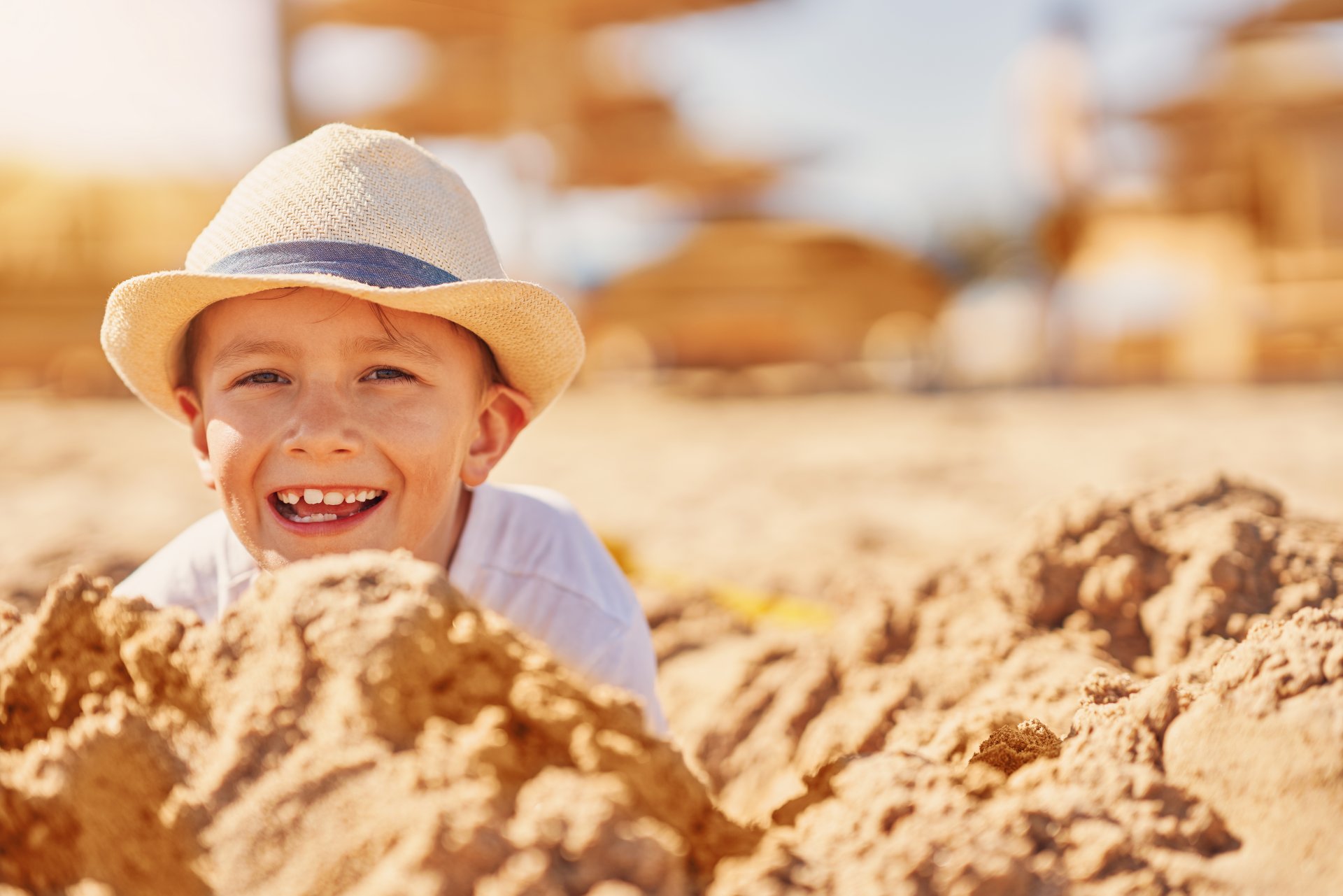 image-of-a-young-boy-playing-with-sand-on-the-beac-2023-05-08-19-08-43-utc