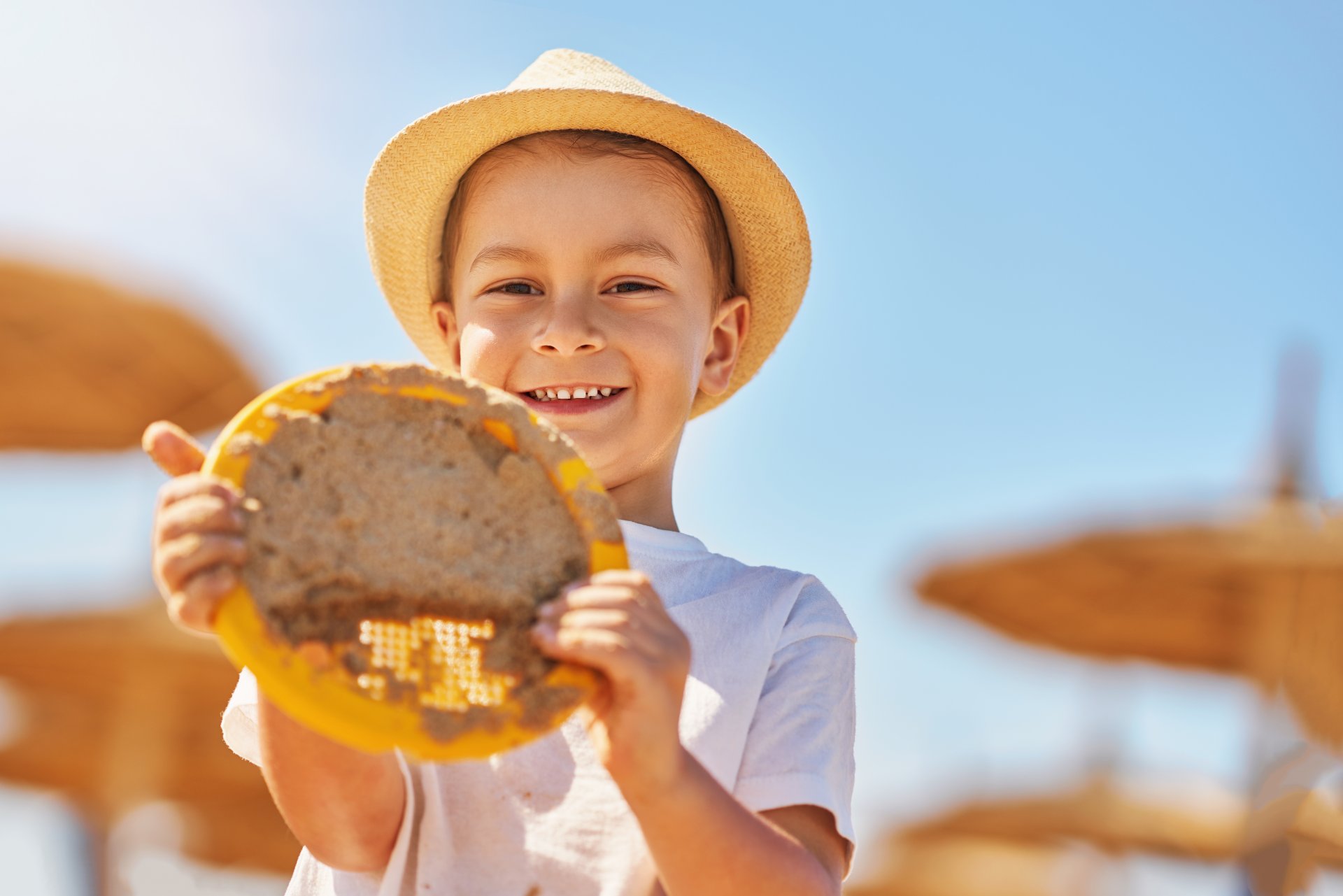 image-of-a-young-boy-playing-with-sand-on-the-beac-2023-05-08-19-08-44-utc