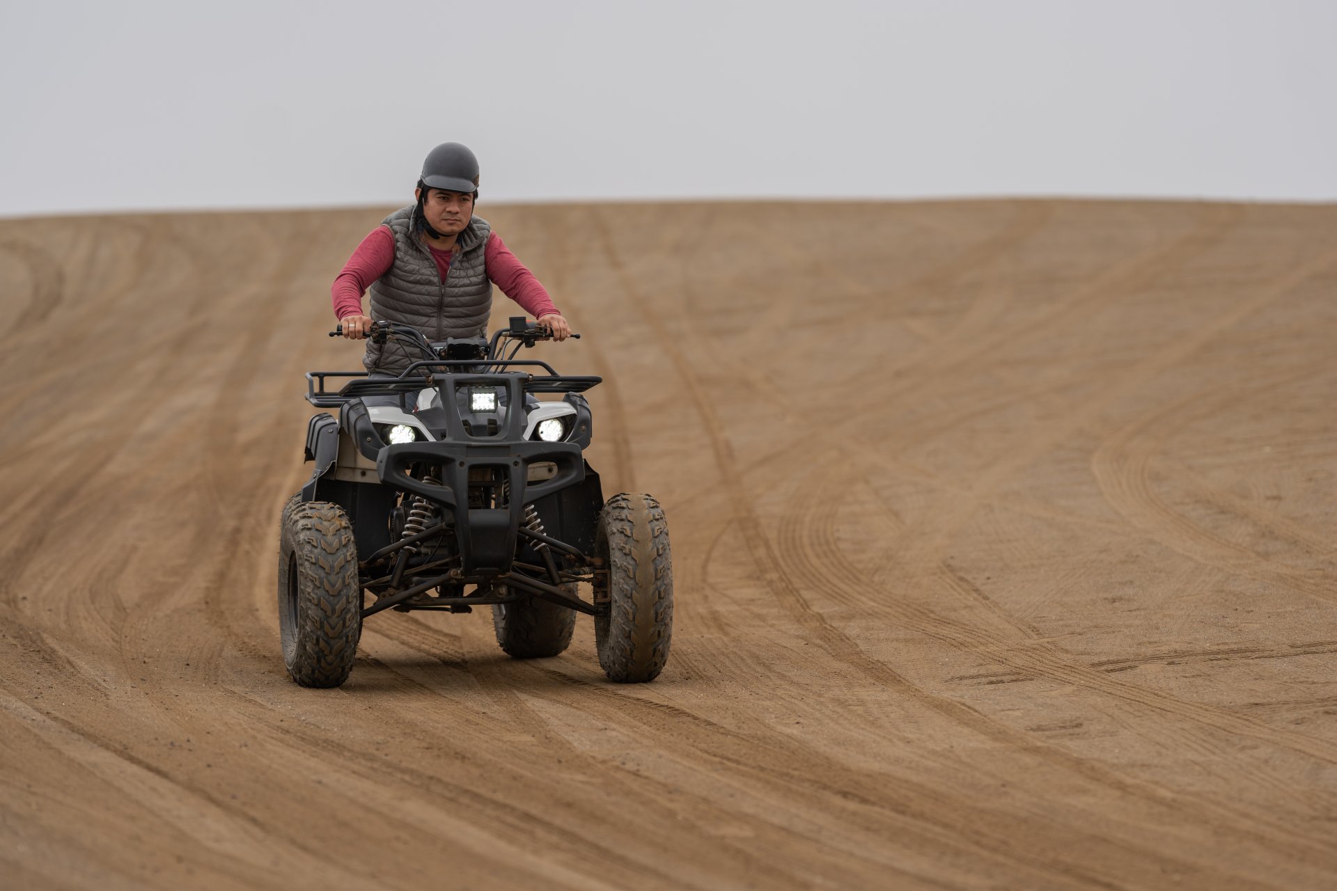 man-driving-a-quad-bike-in-a-sandy-terrain-2023-11-27-05-32-41-utc