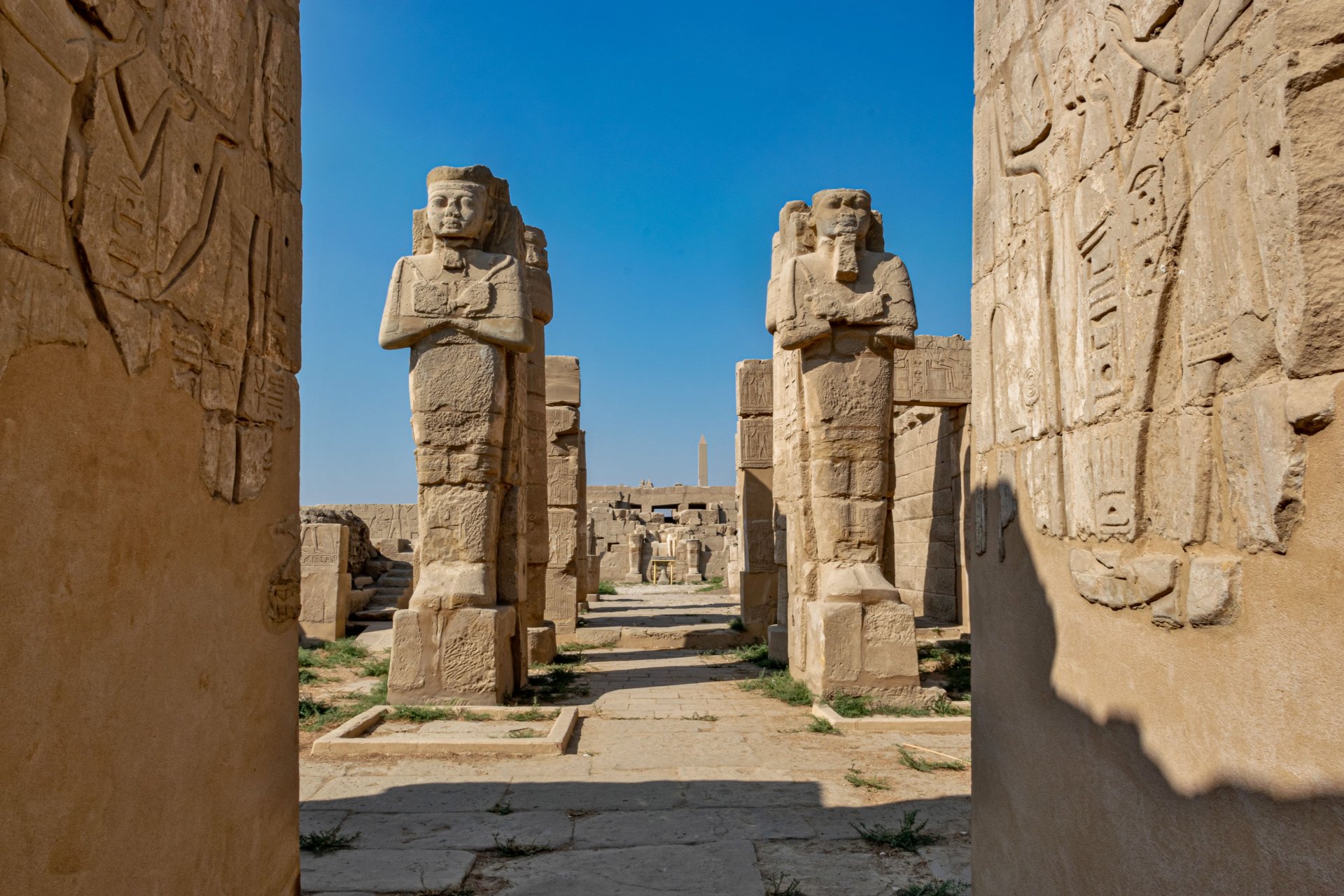 tall-statues-by-the-karnak-temple-on-blue-sky-back-2023-11-27-05-04-23-utc