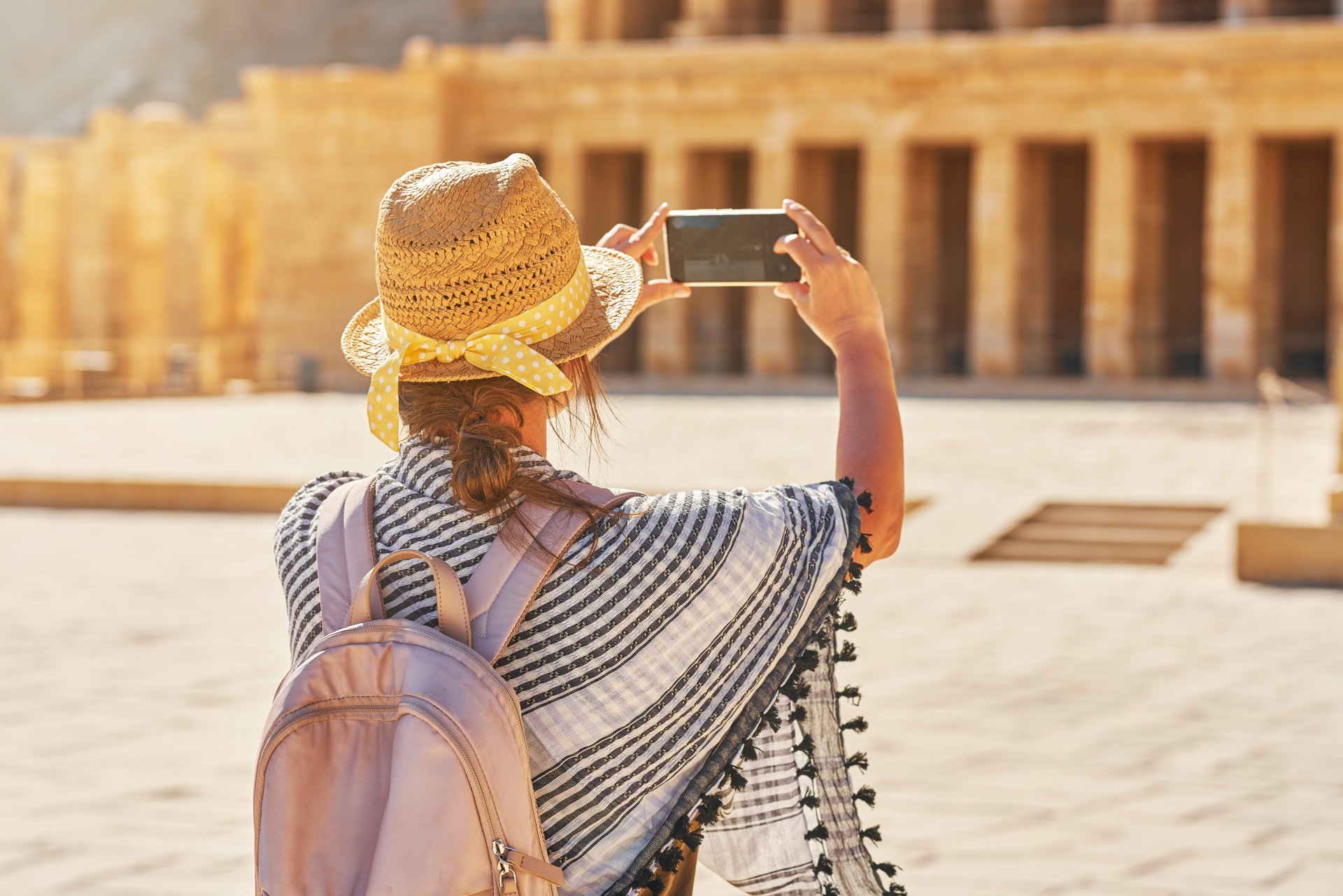 tourist-woman-taking-photo-od-ruins-mortuary-templ-2023-11-27-05-10-29-utc