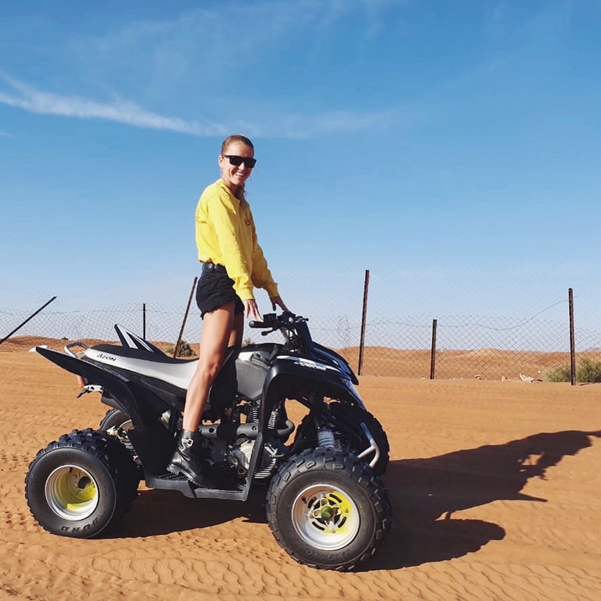 woman-in-the-desert-standing-on-the-quad-bike-2023-11-27-05-33-35-utc